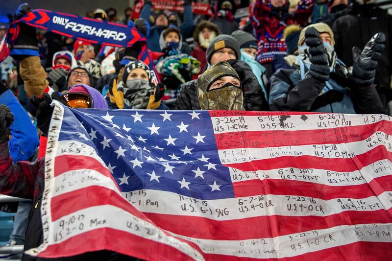 A USA fan holds a flag during the World Cup qualifier Concacaf football match between USA and Honduras.  AFP