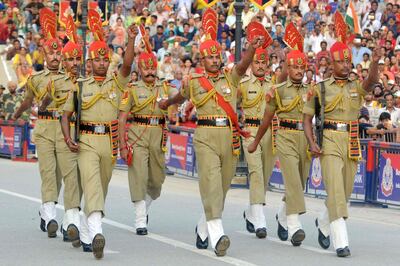 Indian Border Security Force personnel march during the daily beating of the retreat ceremony at the India-Pakistan Wagah Border Post, some 35kms west of Amritsar on August 14, 2017.

Pakistan celebrates its independence on August 14, one day before India's independence day on August 15. / AFP PHOTO / NARINDER NANU