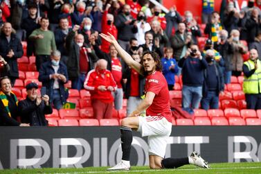 Manchester United's Uruguayan striker Edinson Cavani celebrates scoring the opening goal during the English Premier League football match between Manchester United and Fulham at Old Trafford in Manchester, north west England, on May 18, 2021. RESTRICTED TO EDITORIAL USE. No use with unauthorized audio, video, data, fixture lists, club/league logos or 'live' services. Online in-match use limited to 120 images. An additional 40 images may be used in extra time. No video emulation. Social media in-match use limited to 120 images. An additional 40 images may be used in extra time. No use in betting publications, games or single club/league/player publications. / AFP / POOL / PHIL NOBLE / RESTRICTED TO EDITORIAL USE. No use with unauthorized audio, video, data, fixture lists, club/league logos or 'live' services. Online in-match use limited to 120 images. An additional 40 images may be used in extra time. No video emulation. Social media in-match use limited to 120 images. An additional 40 images may be used in extra time. No use in betting publications, games or single club/league/player publications.