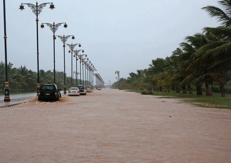 Cars drive through a flooded street as heavy rains and strong winds pummel Oman's Dhofar province. Mohammed Mahjoub / AFP Photo