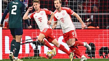 Bayern's Joshua Kimmich, center, and Harry Kane (9) celebrate after Kimmich scored during the Champions League quarter final second leg soccer match between Bayern Munich and Arsenal at the Allianz Arena in Munich, Germany, Wednesday, April 17, 2024.  (Tom Weller / dpa via AP)