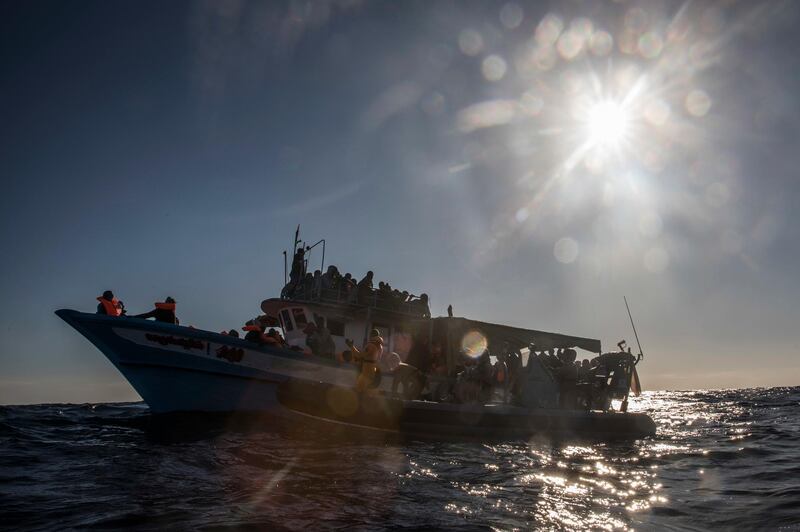 In this Saturday Jan. 27, 2018, photo, 329 refugees and migrants, mostly from Eritrea and Bangladesh, wait to be rescued by aid workers of the Spanish NGO Proactiva Open Arms, after leaving Libya trying to reach European soil aboard an overcrowded wooden boat, 45 miles north of Al-Khums, Libya. (AP Photo/Santi Palacios)