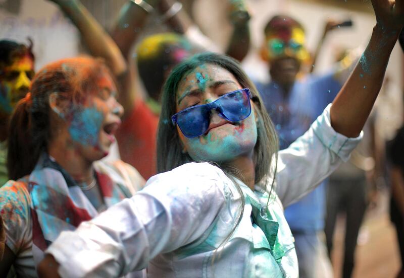 Tourists and locals apply colour dust to each other as they celebrate Holi festival in Kolkata, Eastern India. EPA