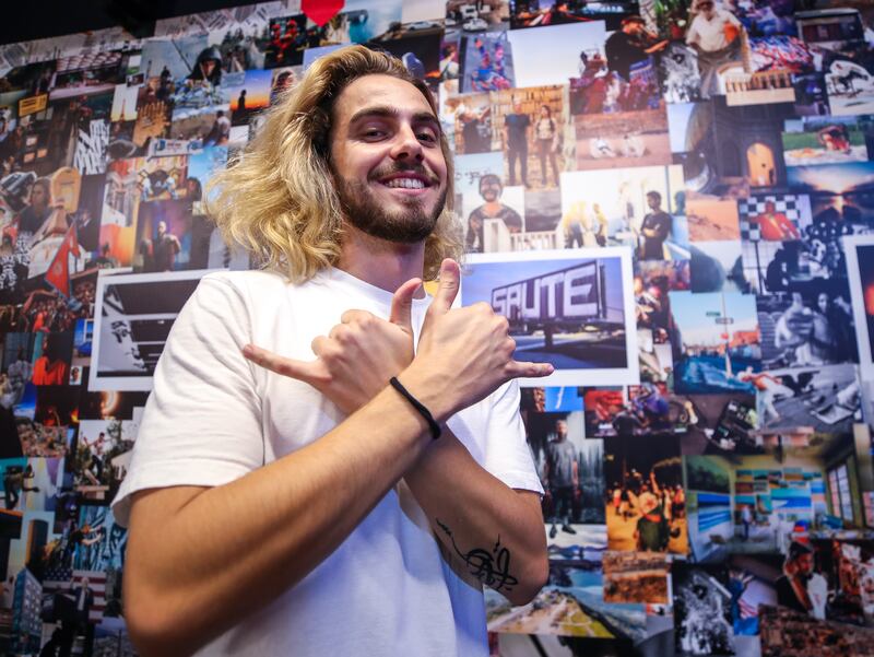 Arthur P, a photographer, in front of his photo collage