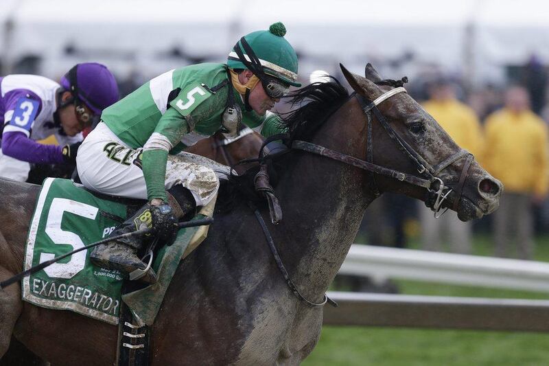 Exaggerator with Kent Desormeaux aboard moves past Nyquist with Mario Gutierrez during the 141st Preakness Stakes at Pimlico Race Course. Garry Jones / AP Photo
