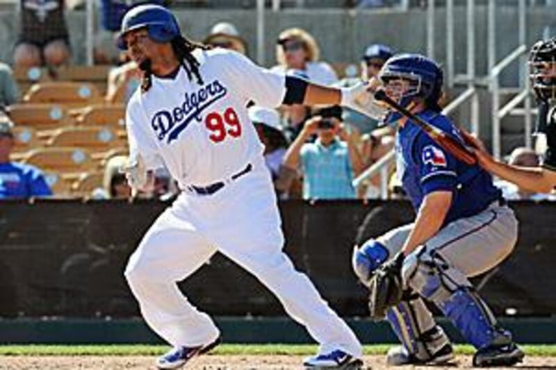 Manny Ramirez hits a single in the fifth innings during a spring training game against the Texas Rangers.