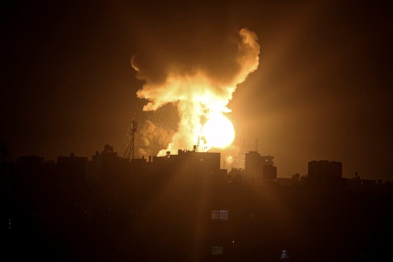 An explosion caused by Israeli airstrikes is seen in the town of Khan Younis, southern Gaza Strip, Sunday January 2, 2022.  Israel’s military says it launched strikes against militant targets in the Gaza Strip, a day after rockets were fired from the Hamas-ruled territory. AP