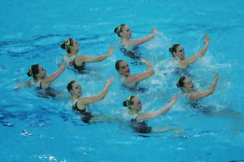 Molecules in liquid water make and break links with each other but retain basic patterns like the synchronised swimmers above.