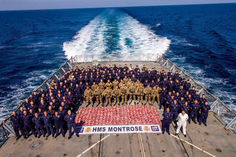 The crew of HMS Montrose stand with 275kg heroin seized from a suspect dhow. (Photo: AET Josh Edwards RN)