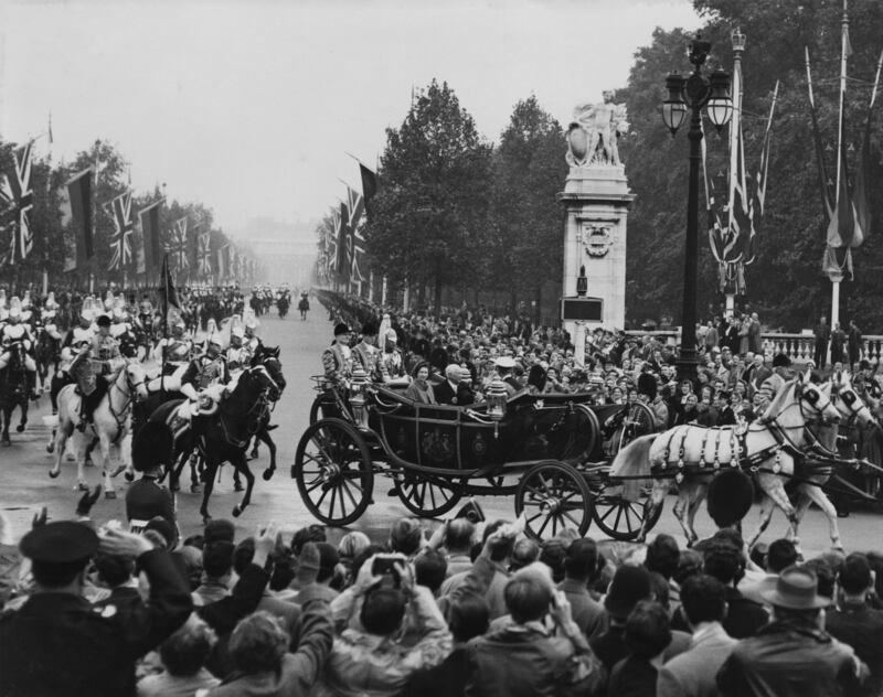 West German President Theodor Heuss travels by landau from Victoria Station in London to Buckingham Palace, accompanied by Queen Elizabeth, in October 1958. Getty Images