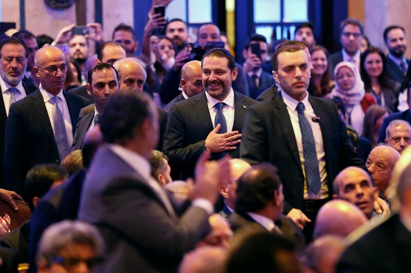 Lebanese Prime Minister Saad Hariri, center, greets the audience on his arrival to a regional banking conference, in Beirut, Lebanon, Thursday, Nov. 23, 2017. Hariri told the conference that the country's stability is his primary concern. The remarks, a day after Hariri suspended his resignation, sought to assure the Hariri's government would keep up the effort to have Lebanon remain a top Mideast destination for finance. (AP Photo/Hussein Malla)
