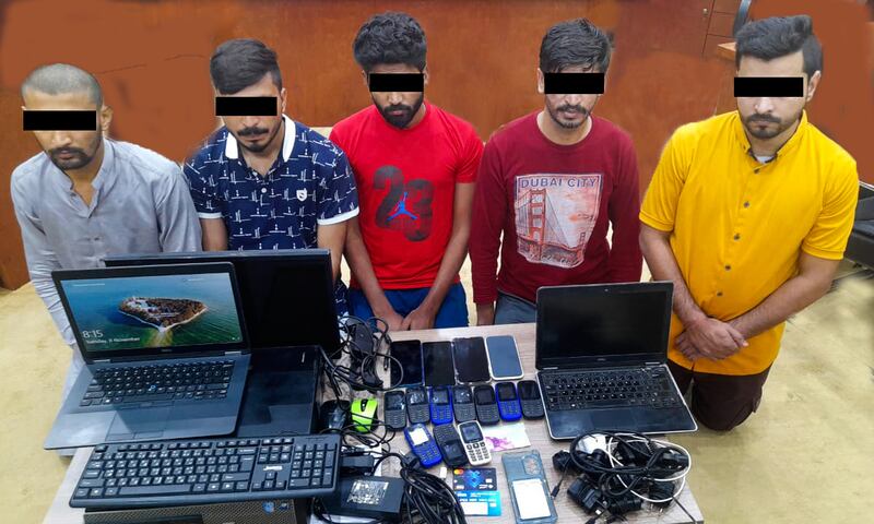 The men accused in the scamming operation posed as staff from banks and public departments and tried to convince people to share their bank details. Photo: Sharjah Police