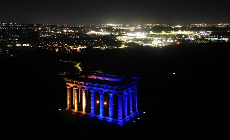 The Penshaw Monument near Sunderland is lit up in blue and yellow, the colours of Ukraine's national flag. PA