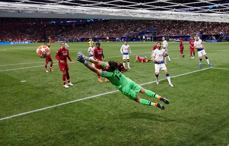 Alisson flies to make a save in the second half against Tottenham Hotspur. Reuters