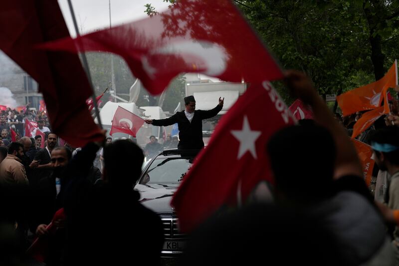 Mr Erdogan's supporters gather outside the AKP's offices in Istanbul. AP