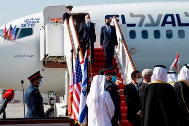 Head of Israel's National Security Council Meir Ben-Shabbat (L) and US Treasury Secretary Steve Mnuchin disembark from a plane upon their arrival at the Bahraini International Airport on October 18, 2020. Israel and Bahrain will officially establish diplomatic relations at a ceremony in Manama, an Israeli official said, after the two states reached a US-brokered normalisation deal last month. / AFP / Mazen Mahdi