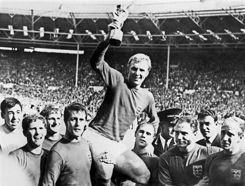 England captain Bobby Moore holding aloft the Jules Rimet trophy as he is carried by his teammates following England's victory over Germany (4-2 in extra time) in the World Cup final on July 30, 1966 at Wembley Stadium. AFP