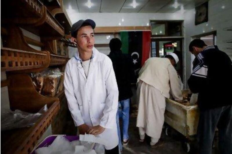 Mokhtar Lebeidi works as a volunteer baker in a bread shop in Benghazi to fill the void left in Libya's workforce by fleeing foreign workers.