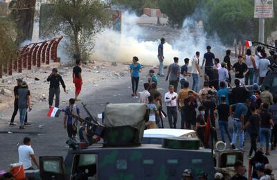 Iraqis protest against the government and the lack of basic services outside the regional government headquarters in the southern city of Basra on September 5, 2018. - Iraqi security forces opened fire on protesters today as the two sides clashed in the southern city of Basra, a day after six people were killed in demonstrations over poor public services. (Photo by Haidar MOHAMMED ALI / AFP)