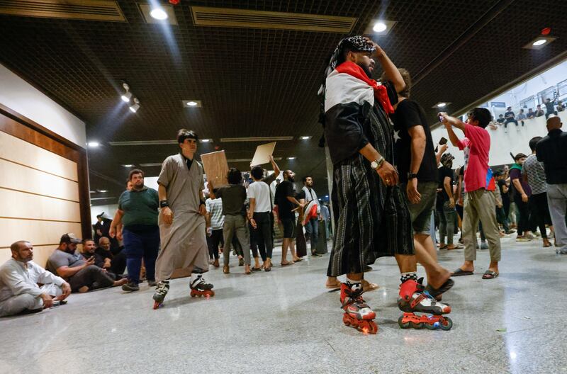 Supporters of Iraqi Shi'ite cleric Moqtada al-Sadr in roller skates attend a protest against corruption, inside the parliament in Baghdad. Reuters