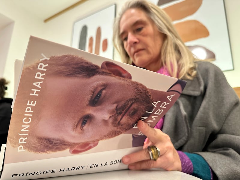 A woman reads a Spanish language copy of Prince Harry's memoir in Barcelona, Spain. AP