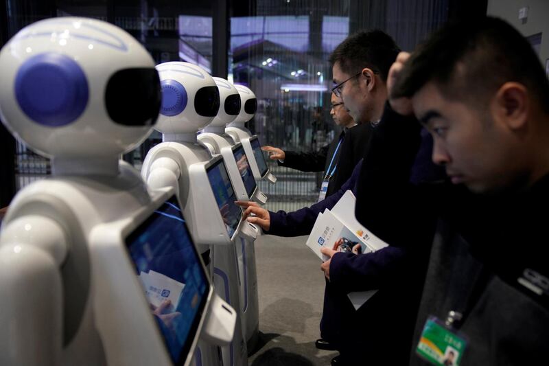 People look at Xiao Qiao robots during the fourth World Internet Conference in Wuzhen, Zhejiang province, China, December 3, 2017. REUTERS/Aly Song