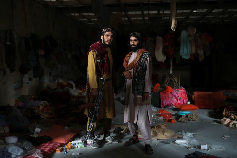 Taliban soldiers Seifatollah and Vasighollah stand in a prison in Bagram Air Base. Reuters