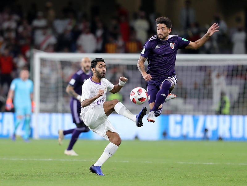 Al Ain, United Arab Emirates - December 18, 2018: River Plate's Milton Casco and Al Ain's Hussein Elshahat battle during the game between River Plate and Al Ain in the Fifa Club World Cup. Tuesday the 18th of December 2018 at the Hazza Bin Zayed Stadium, Al Ain. Chris Whiteoak / The National