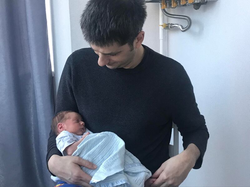 Londoner Ben Garratt holds his one-month-old son Raphael in Kiev, Ukraine. Mr Garratt and his wife Alice are awaiting a passport for their baby, born to a surrogate mother in Ukraine, in order to be allowed to bring the baby to Britain. Photo: Ben Garratt/PA
