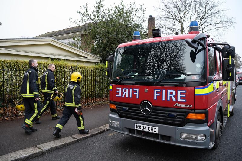 Firefighters head back to their trucks after tackling a fire which destroyed a number of buildings at London Zoo. Leon Neal / Getty Images.