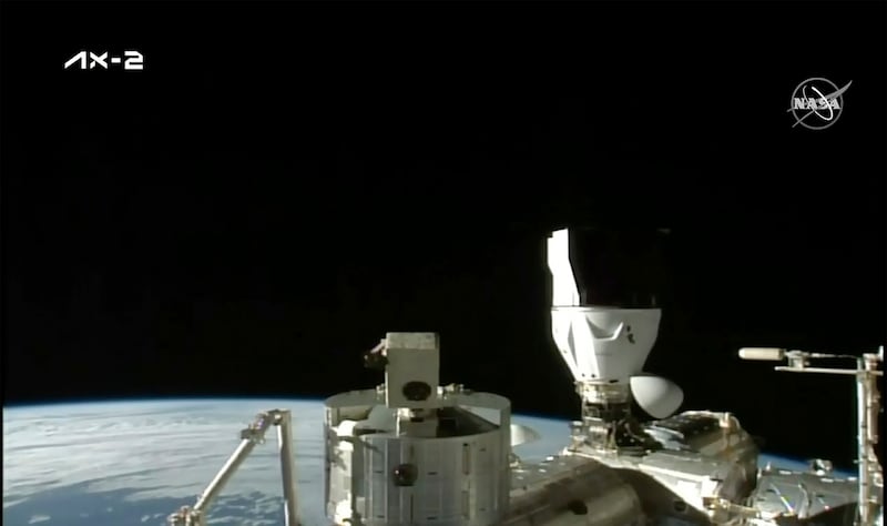 The Sun rises over the ISS after the SpaceX capsule docks. AP