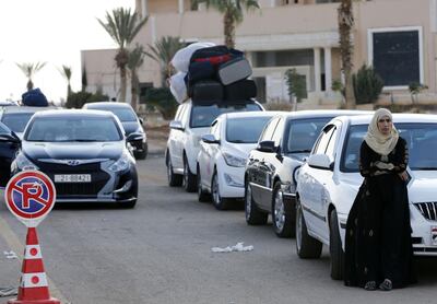 Vehicles wait to cross at the recently reopened Nassib border post in the Deraa province,at the Syrian-Jordanian border south of Damascus on November 7, 2018.  Syrian regime forces retook control of the Nassib border crossing from rebels in July, and last month reopened it after a three-year closure, allowing Jordanians to dash over for cheap shopping. / AFP / LOUAI BESHARA
