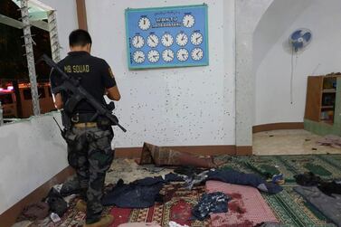 A police investigator examines the scene of a grenade attack of a Muslim mosque in Zamboanga, January 30, 2019. AP