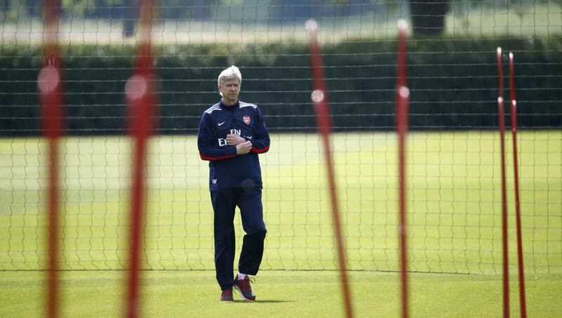 Arsenal manager Arsene Wenger orchestrates a team training session on Wednesday ahead of the FA Cup final on Saturday. Eddie Keogh / Reuters / May 14, 2014