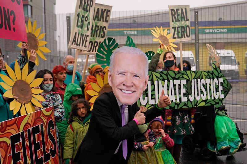 A climate activist wearing a mask of US President Joe Biden takes part in a demonstration against the use of fossil fuels. AP Photo
