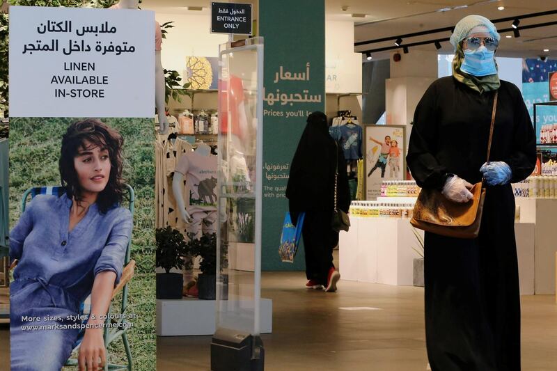 A woman wearing a protective mask walks at a shopping mall after the Saudi government eased a curfew and allowed stores to open, following the outbreak of the coronavirus disease. Reuters