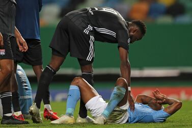 Lyon's Moussa Dembele consoles Manchester City's Raheem Sterling at the end of the Champions League quarterfinal. AP