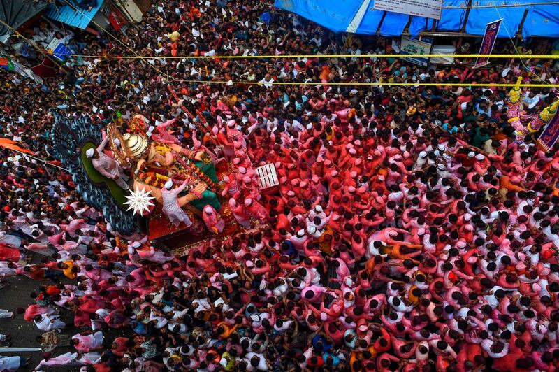 Devotees march with an idol of the elephant-headed Hindu deity Ganesha during a procession on the last day of the Ganesh Chaturthi festival in Mumbai.  AFP