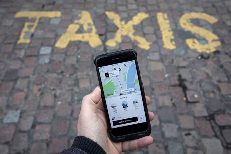FILE PHOTO:    A photo illustration shows the Uber app on a mobile telephone, as it is held up for a posed photograph, in London, Britain November 10, 2017.  REUTERS/Simon Dawson/File Photo
