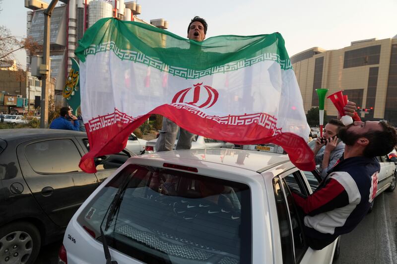 People celebrate after Iran's World Cup win over Wales. The political turmoil that followed the death of Mahsa Amini in police custody has cast a shadow over Iran's matches at the World Cup and global energy supplies.AP