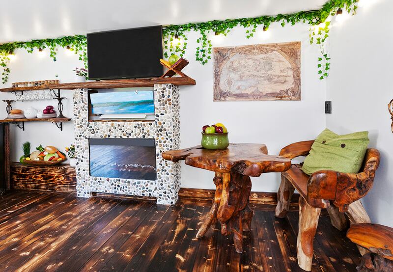 A wooden chair and table beneath a map of Middle Earth. Photo: Dasha Wright