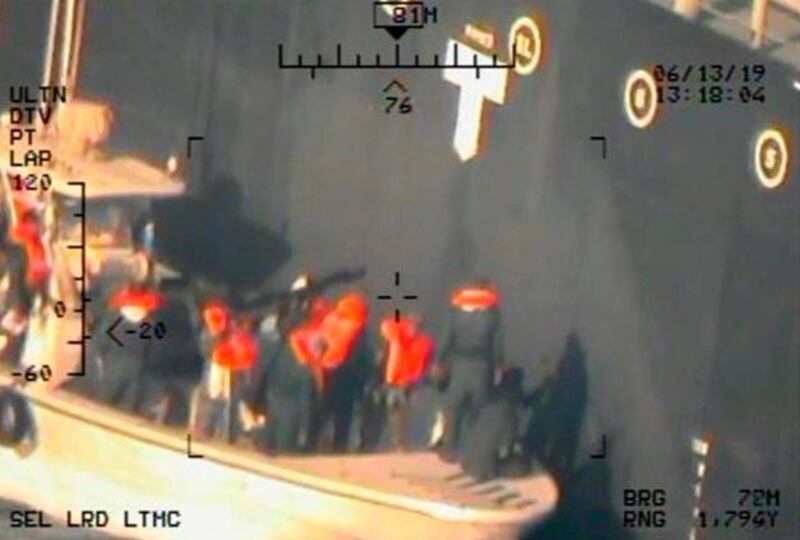 Members ofwhat many believe to be the Islamic Revolutionary Guard Corps Navy remove an unexploded limpet mine from the M/T Kokuka Courageous in the Sea of Oman. AP