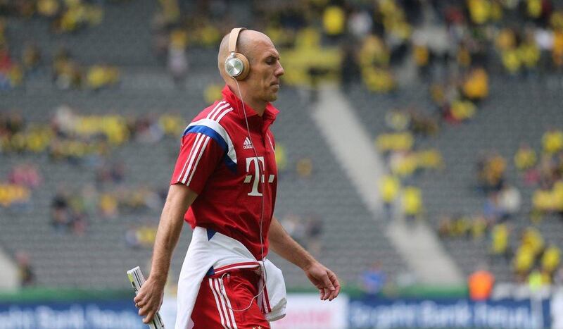 Bayern Munich player Arjen Robben walks across the pitch wearing headphones before the DFB-Pokal (German Cup) final against Borussia Dortmund on Saturday at the Berlin Olympic Stadium. Kay Nietfeld / EPA / May 17, 2014