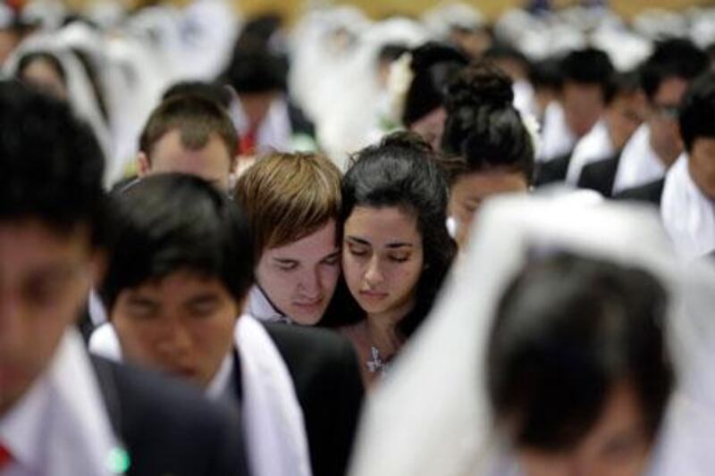 Couples from around the world pray in a mass wedding ceremony at the CheongShim Peace World Centre in Gapyeong, South Korea, on Sunday. Lee Jin-man / AP Photo
