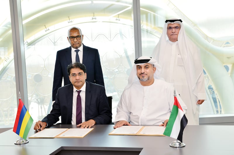 Seated from left, Harvesh Kumar Seegolam, governor of the Bank of Mauritius and Mohammed Helal Al Mheiri, director general of Abu Dhabi Chamber, and standing from left, Mauritius's Minister of Finance and Economic Development Renganaden Padayachy and Abdullah Mohammed Al Mazrouei, Chairman of the Abu Dhabi Chamber, sign an agreement. Photo: Abu Dhabi Chamber
