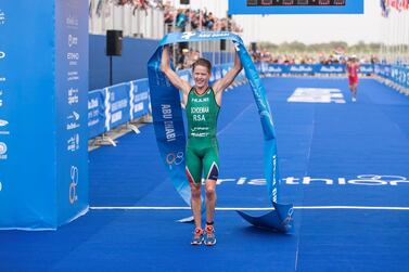 Henri Schoeman raises the finishing tape after winning the ITU World Triathlon Abu Dhabi. Reem Mohammed / The National