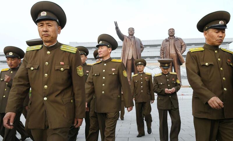 North Korean soldiers marking the 85th anniversary of the founding of the Korean People’s Army walk in front of the bronze statues of Kim Il-sung and Kim Jong-il in Pyongyang. Kyodo / via Reuters