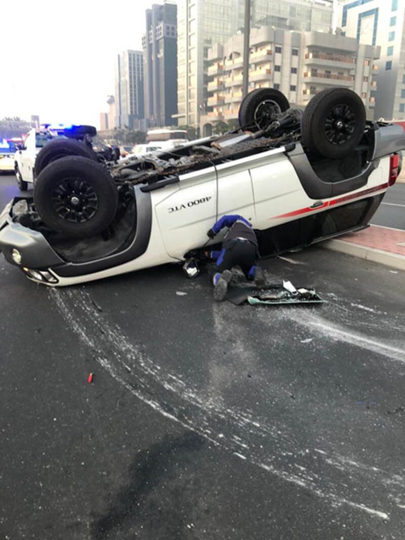 A driver was injured when his car flipped over after crashing into a road barrier. Courtesy: Dubai Police  