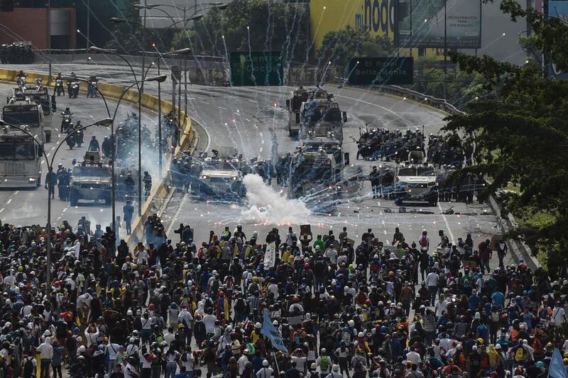 Clashes between police with opposition demonstrators in Caracas, Venezuela. Carlos Becerra / AFP Photo