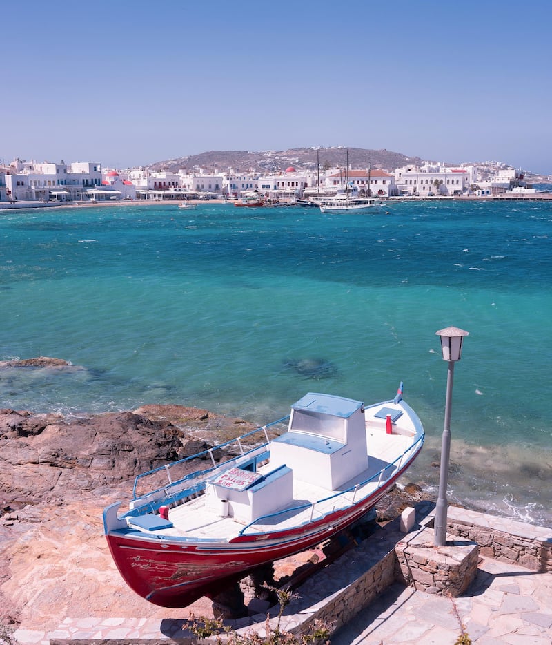 A boat on land by the sea overlooking the old port in Mykonos, Greece. Loulou D'Aki/Bloomberg